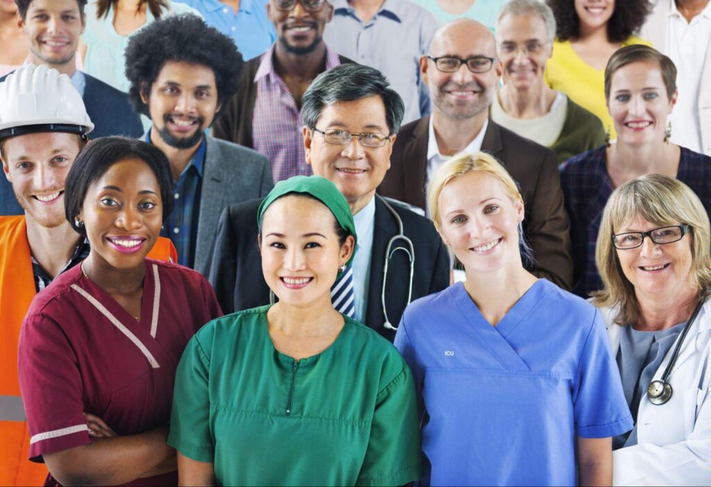 A group of diverse individuals working in healthcare are smiling.