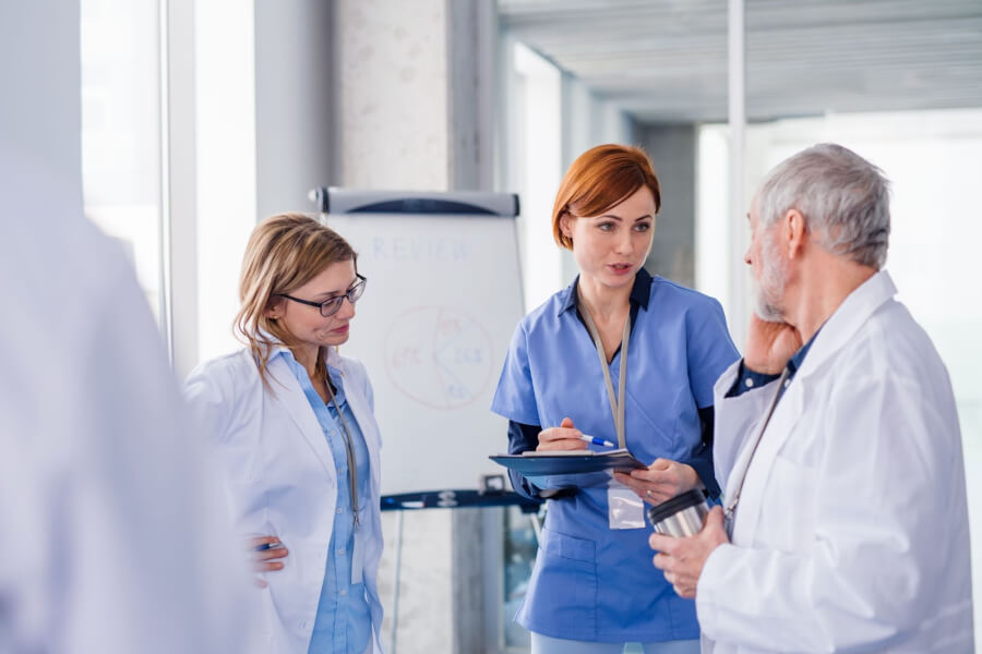 A group of medical professionals discuss how to hire a doctor.